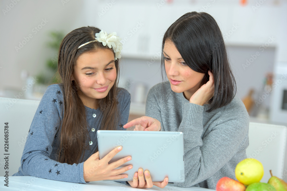 mother and daughter with tablet pc mother and daughter with tablet pc