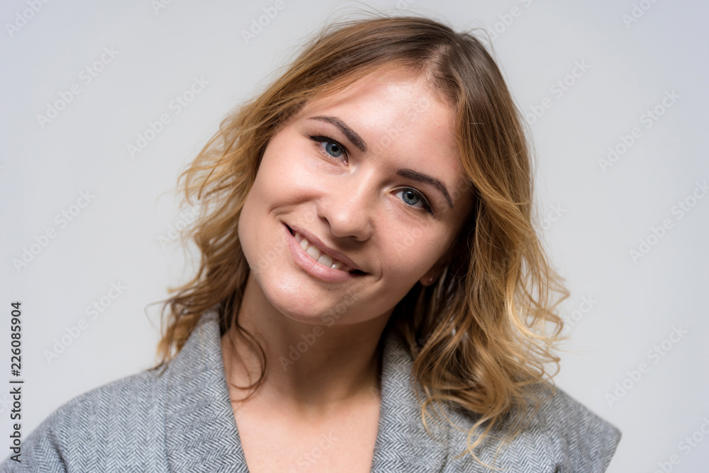 Portrait of a beautiful blonde girl on a white background in a dress. Portrait of a beautiful blonde girl on a white background in a dress.