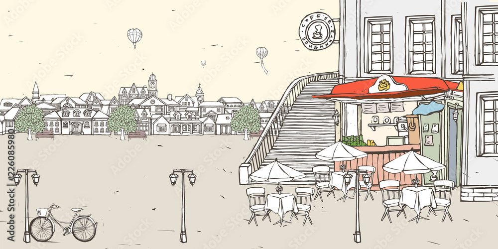 Roadside cafe with buildings in background and hot air balloon flying against sky