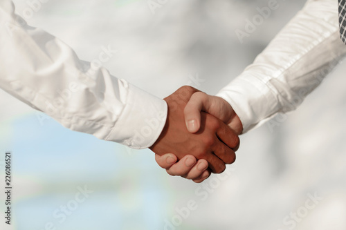 Close-up photo of handshake of two successful businessmen