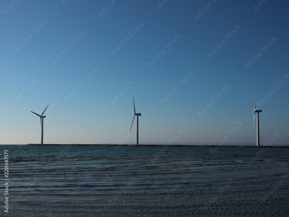 Line of Offshore Windmill Turbine at Sea