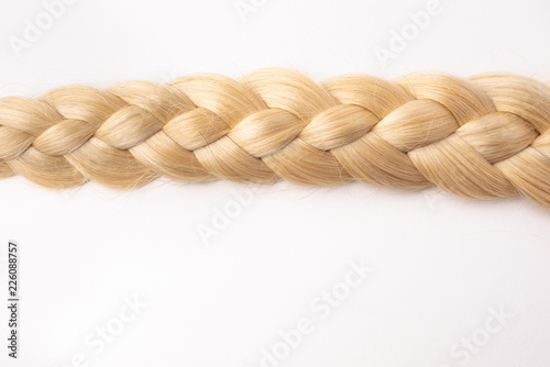 Human, natural light blond hair tress on white isolated background. An example of a fashionable hairstyle for a poster, an advertisement or a hairdressing website. photo