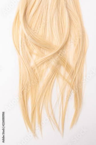 Human, natural light blond straight hair on white isolated background. An example of a fashionable hairstyle for a poster, an advertisement or a hairdressing website.