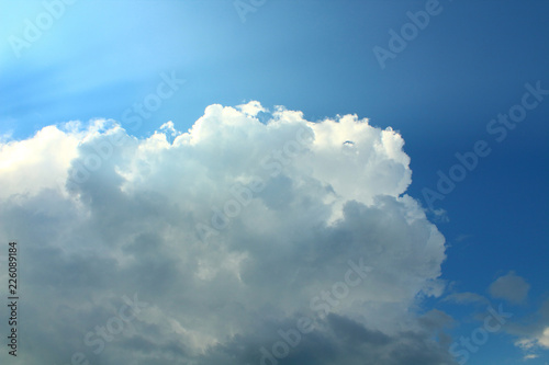 Large lush clouds and sunrays. Background. Landscape.