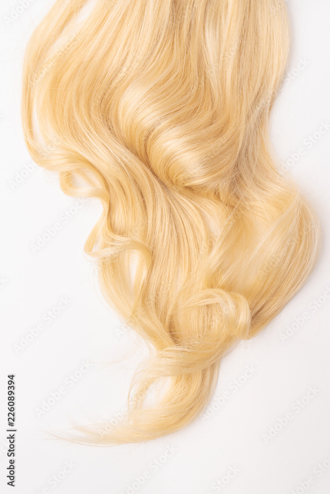 Human, natural light blond wavy hair on white isolated background. An example of a fashionable hairstyle for a poster, an advertisement or a hairdressing website. Human, natural light blond wavy hair on white isolated background. An example of a fashionable hairstyle for a poster, an advertisement or a hairdressing website.