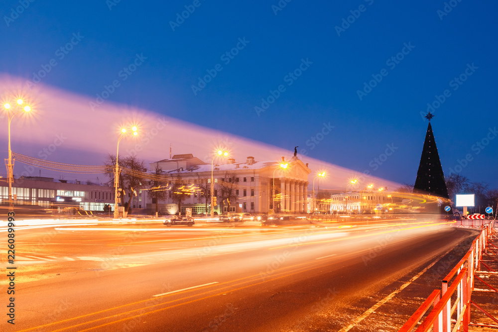 Movement of cars on the city square at night