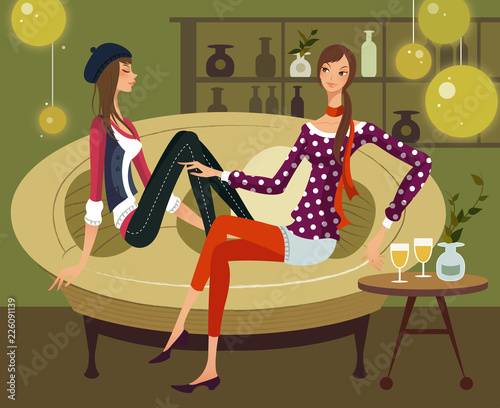 Two women sitting together on a couch