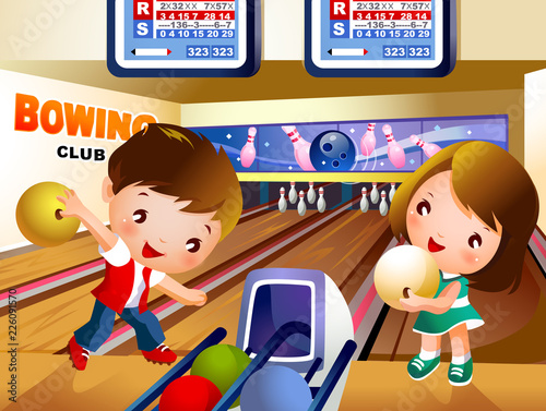 Boy bowling in bowling alley with a girl holding a ball