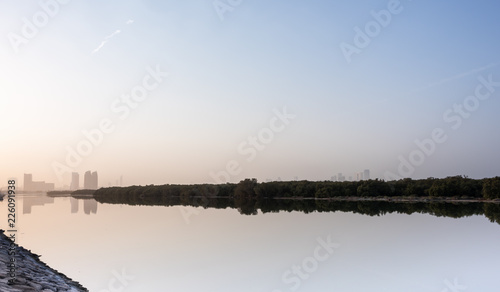Al Bahr Towers and Mangroves reflection in the sea