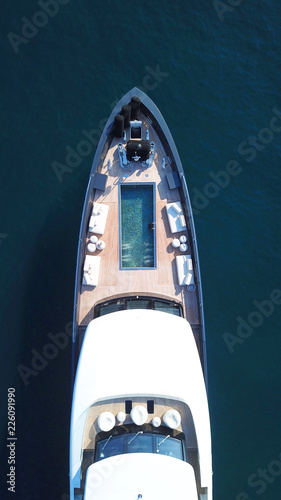 Aerial photo of luxury yacht in iconic island of Mykonos, clear waters of Super Paradise beach, Cyclades, Greece © aerial-drone
