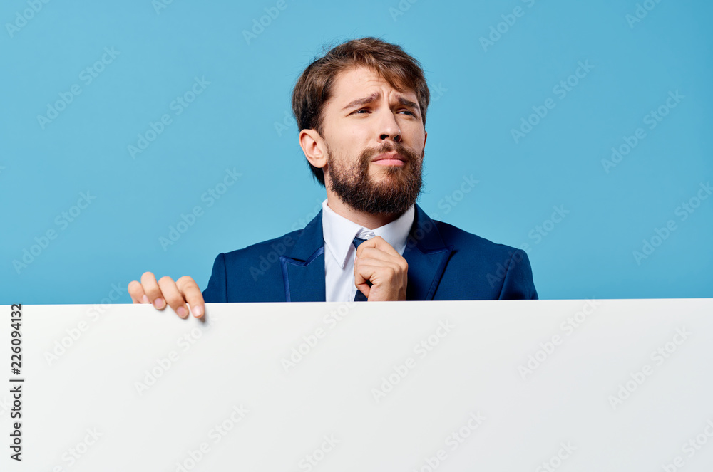 business man holding a paper on a blue background free space business man holding a paper on a blue background free space