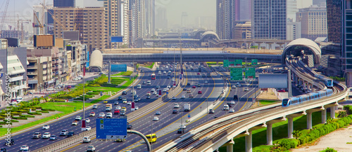 Dubai city street or road full of cars and metro. United Arab Emirates