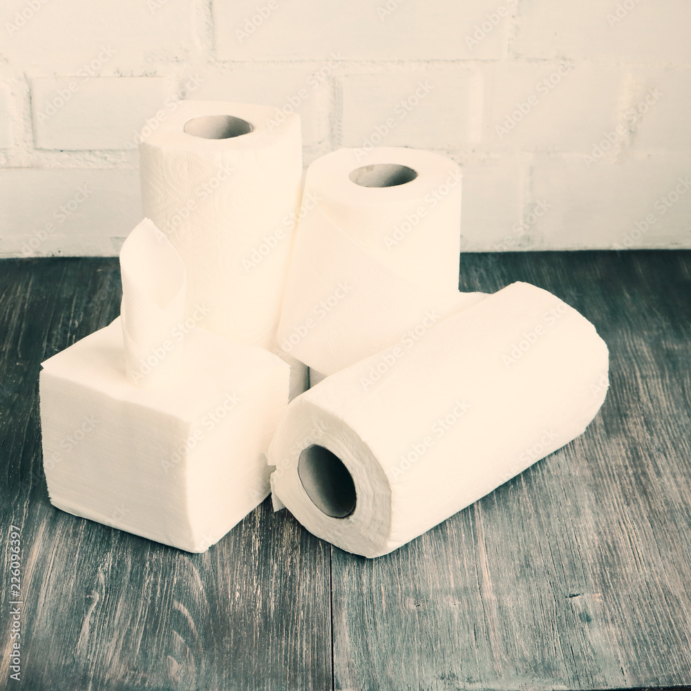 White kitchen paper towel, toilet paper, tissue, napkins on a dark wooden  table. Concept of kitchen and hygienic disposables. Stock Photo | Adobe  Stock