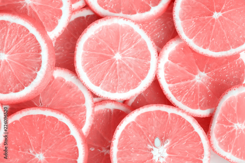 Pink citrus fruits - cuts, slices, halves. Closeup of pink fruits, oranges, grapefruits. photo