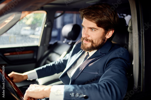 man sits in a luxury car