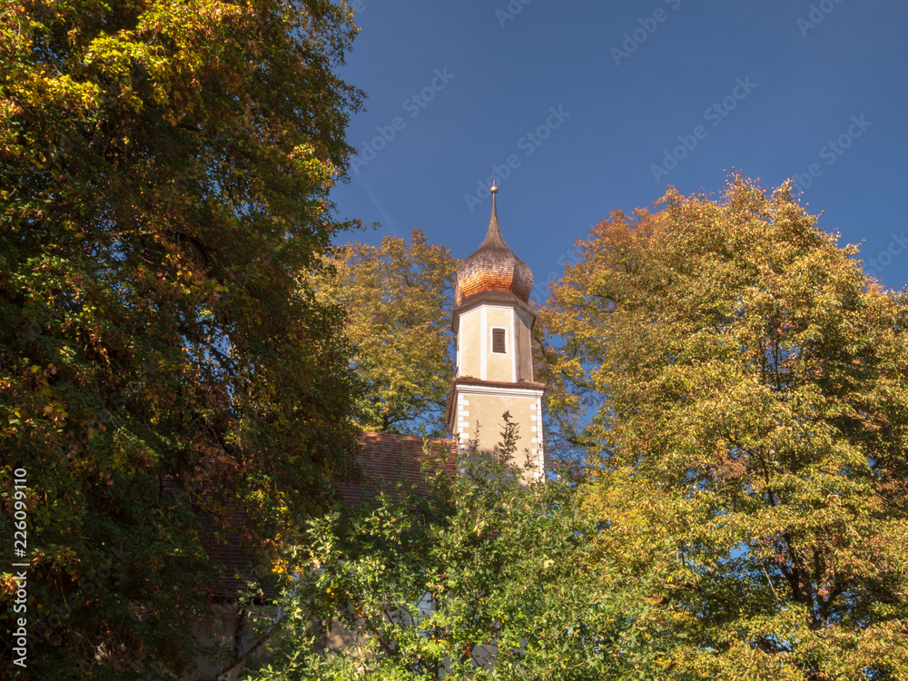 Scenic view to church tower inside the forest in bavaria