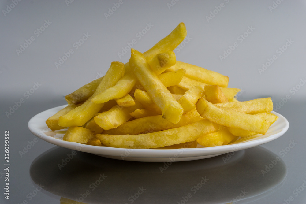 Potato fry or fries on dark background Potato fry or fries on dark background