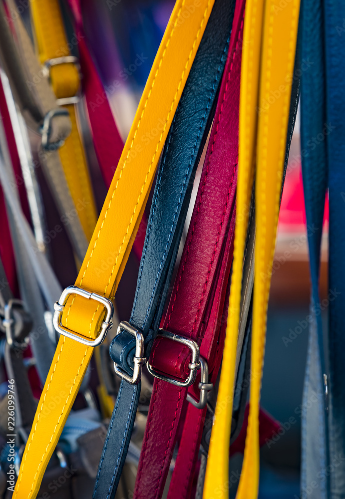 Background from a variety of colored belts closeup.