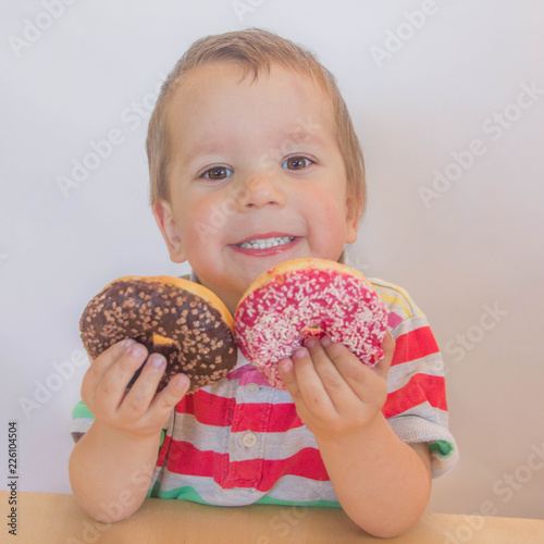 child chooses sweets. boy with a donut.