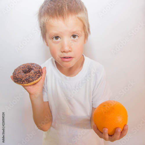 child chooses sweets. boy with a donut.