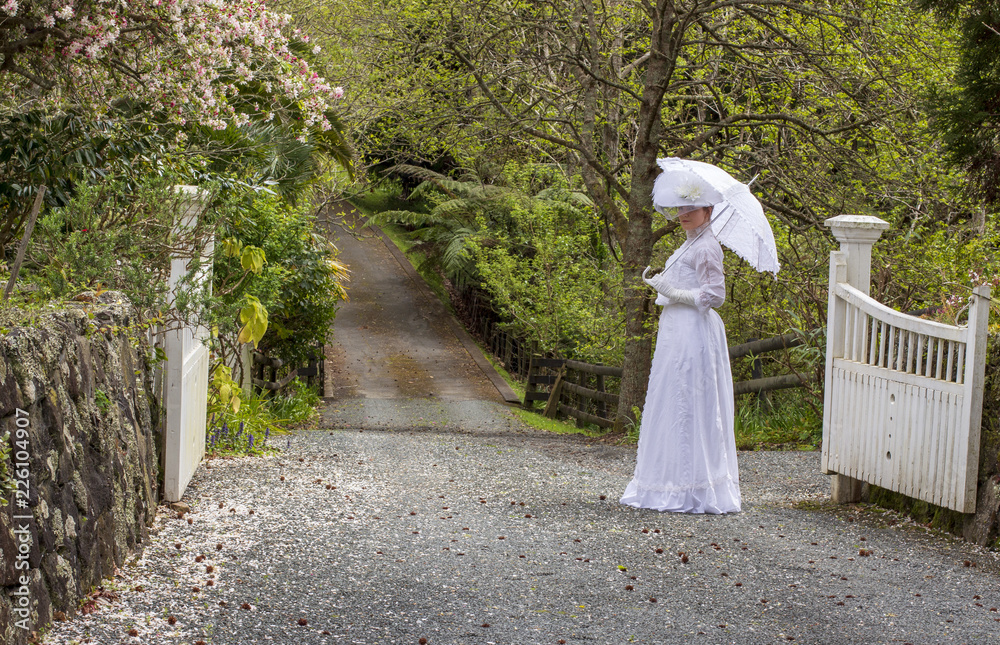 Edwardian woman holding parasol in garden Edwardian woman holding parasol in garden