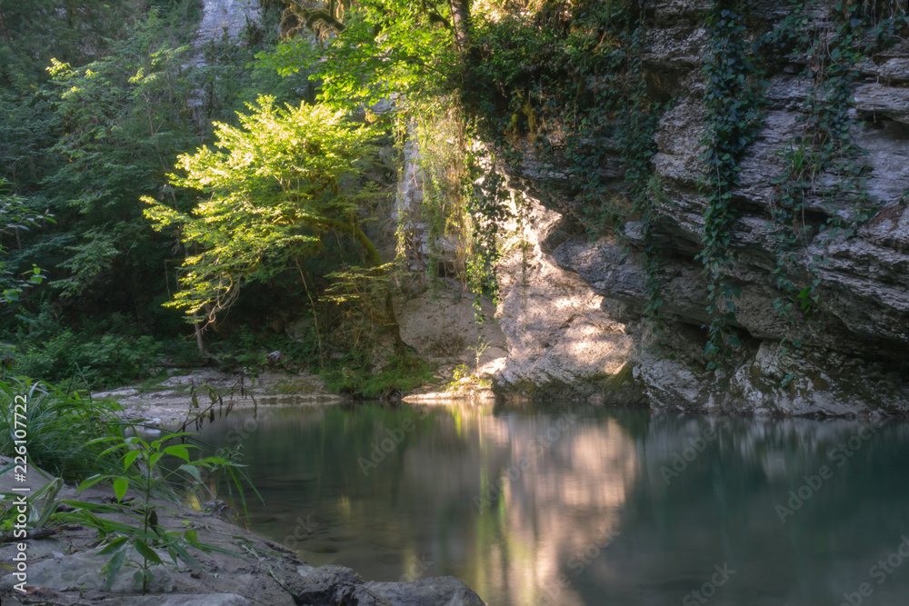 spots of light on a rock above a mountain river Creek, Caucasus mountains, Russia spots of light on a rock above a mountain river Creek, Caucasus mountains, Russia