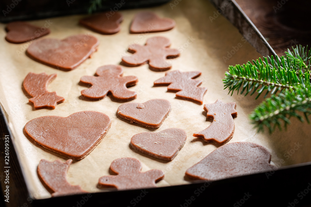 Sweet Christmas gingerbread cookies on baking tray