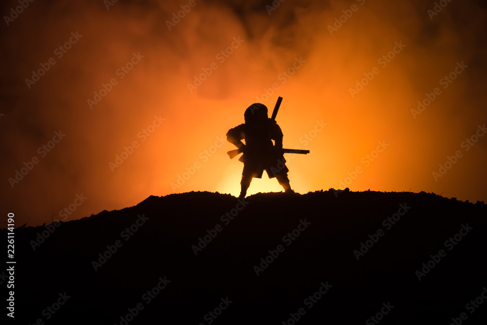 Fighter with a sword silhouette a sky ninja. Samurai on top of mountain with dark toned foggy background. Fighter with a sword silhouette a sky ninja. Samurai on top of mountain with dark toned foggy background.