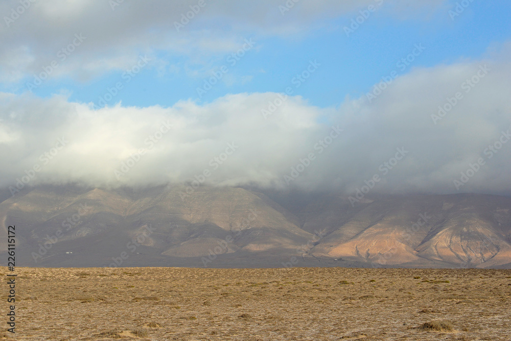 layered view of the desert, mountain and clouds in the evening haze