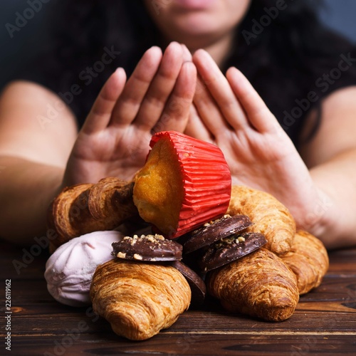Obesity prevention, conscious eating, nutrition choices, mindfulness and healthy lifestyle.  Addicted woman refuse to eat sweets, close up