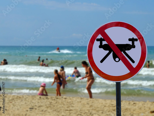 sign ban drones in the background of the beach with the tourists people