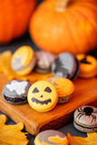 Halloween scary cookies with pumpkin on wooden cut board. pattern Bat , patina, ghosts and spiders. Gray color background,