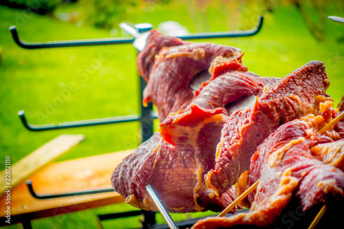 Close up of selective focus of raw meatn skewers in a blurred backyard background on Pucon photo