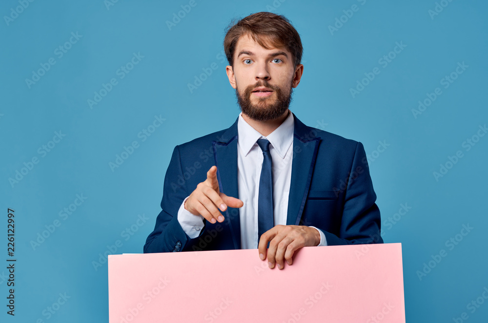 business man shows his finger in the camera holding pink paper business man shows his finger in the camera holding pink paper