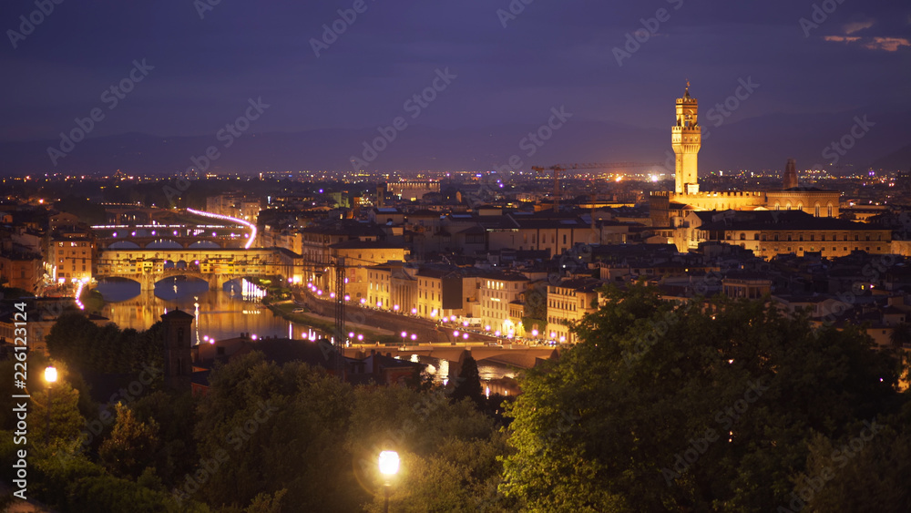 In focus backdrop of Florence, Italy at night with bright city lights
