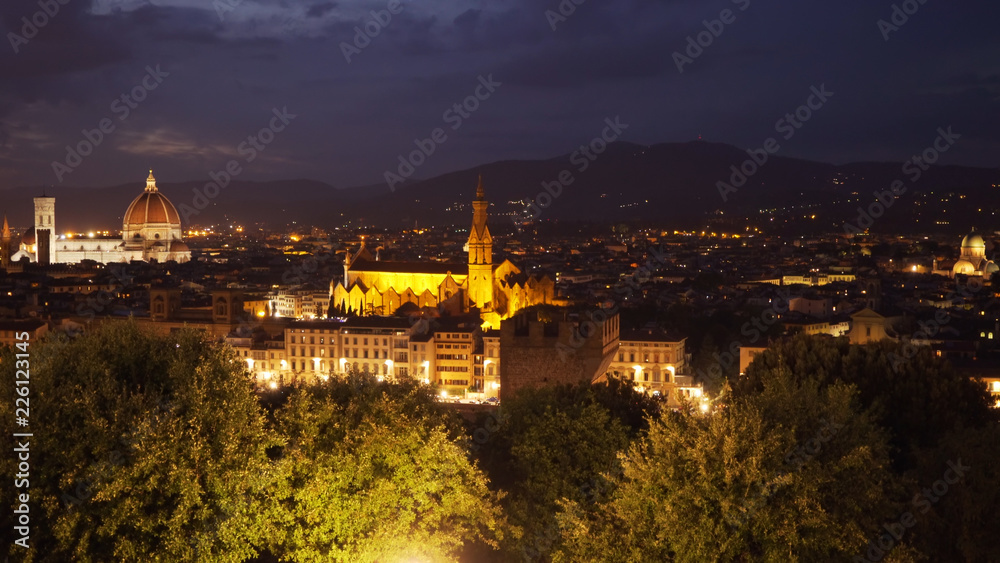 Brightly lit city view of Florence Italy with landmarks in the distance