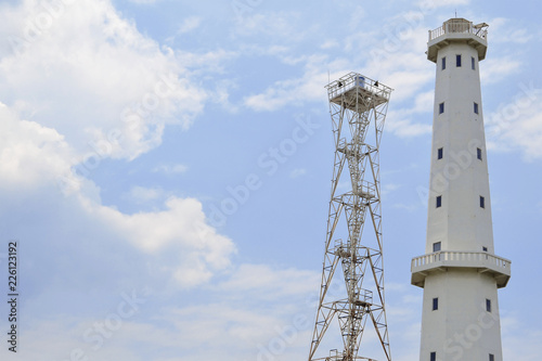 White mercusuar and watchtower on Puger Beach, Indonesia during the day
