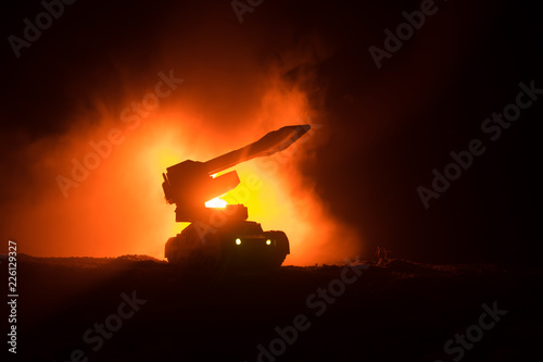 Rocket launch with fire clouds. Battle scene with rocket Missiles with Warhead Aimed at Gloomy Sky at night. Rocket vehicle on War Backgound
