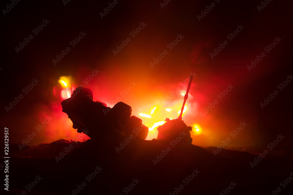 War Concept. Military silhouettes fighting scene on war fog sky background, World War German Tanks Silhouettes Below Cloudy Skyline At night. Attack scene. Armored vehicles. Tanks battle