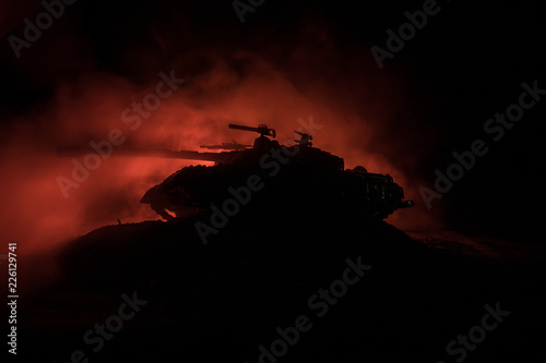 War Concept. Military silhouettes fighting scene on war fog sky background  World War German Tanks Silhouettes Below Cloudy Skyline At night. Attack scene. Armored vehicles. Tanks battle