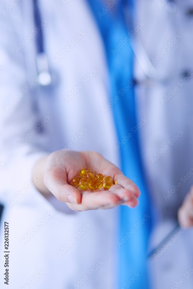 Close-up shot of doctor's hands holding pills. Close-up shot of doctor's hands holding pills.