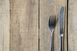 Silver knife and fork on the wooden table
