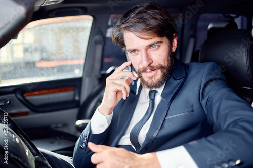 luxury business man talking on the phone sitting in the car © SHOTPRIME STUDIO