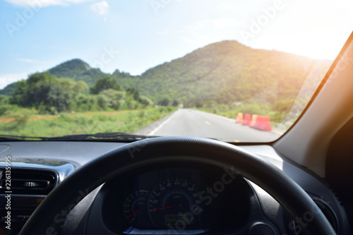 Car driving on road mountain sky background