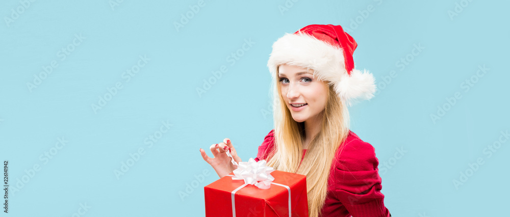 Young and beautiful girl in a Christmas hat. Winter concept.