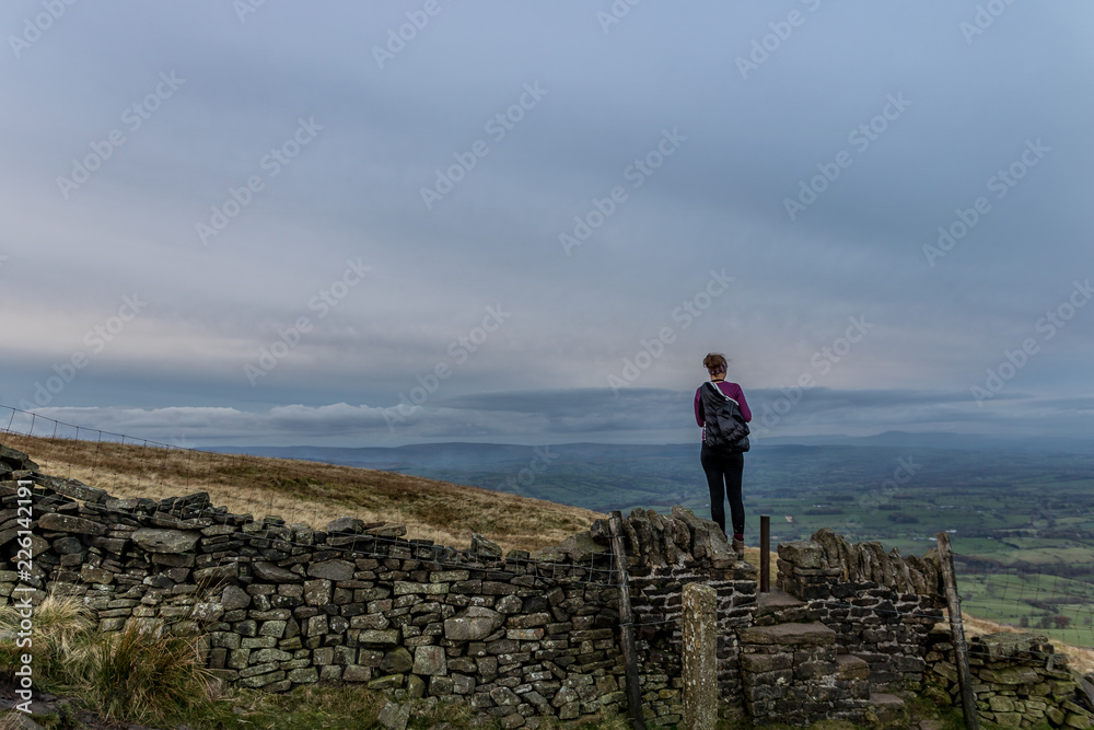 Landscape on top of hill with girl from behind when she looking far away