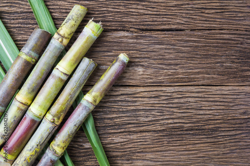 Close up sugarcane on wood background close up.. © bumbumbo