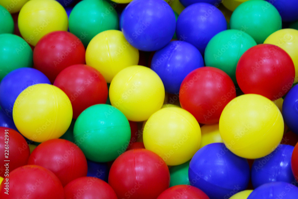 Many colorful plastic balls in a kids' ballpit at a playground. Many colorful plastic balls in a kids' ballpit at a playground.