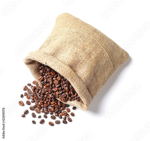 Overturned bag with roasted coffee beans on white background, top view