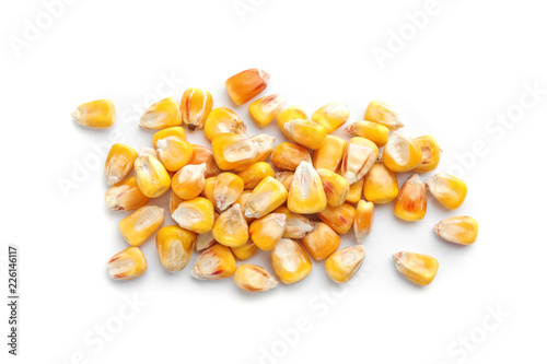 Dried corn kernels on white background, top view